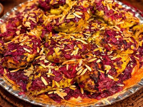 Mosakhan glistening with olive oil and sumac, scattered with almonds